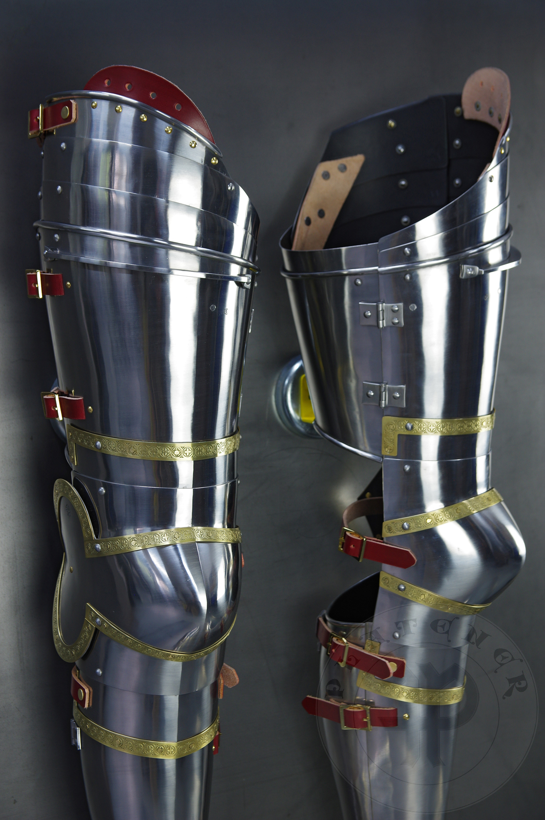 Complete leg harness mainly inspired by depicts from Altar of St George of the Valencian school, circa 1410. Cuisses are quite unusual with such detail like lames on upper part of thigh plates and stop ribs. They are also closed at the back like in English style armour. All made of medium carbon steel and heat hardened and tempered up to 42 HRC./Pene osony ng gwnie inspirowane przedstawieniami z otarza w. Jerzego z warsztatu z Walencji, okoo 1410 rok. Nabiodrki s do nietypowe z takimi detalami jak dodatkowe folgi oraz kute wzmocnienie ochronne. S one take w peni zamknite podobnie jak w angielskim stylu. Wykonane w caoci ze stali redniowglowej oraz hartowane i odpuszczane do twardoci 42 HRC.